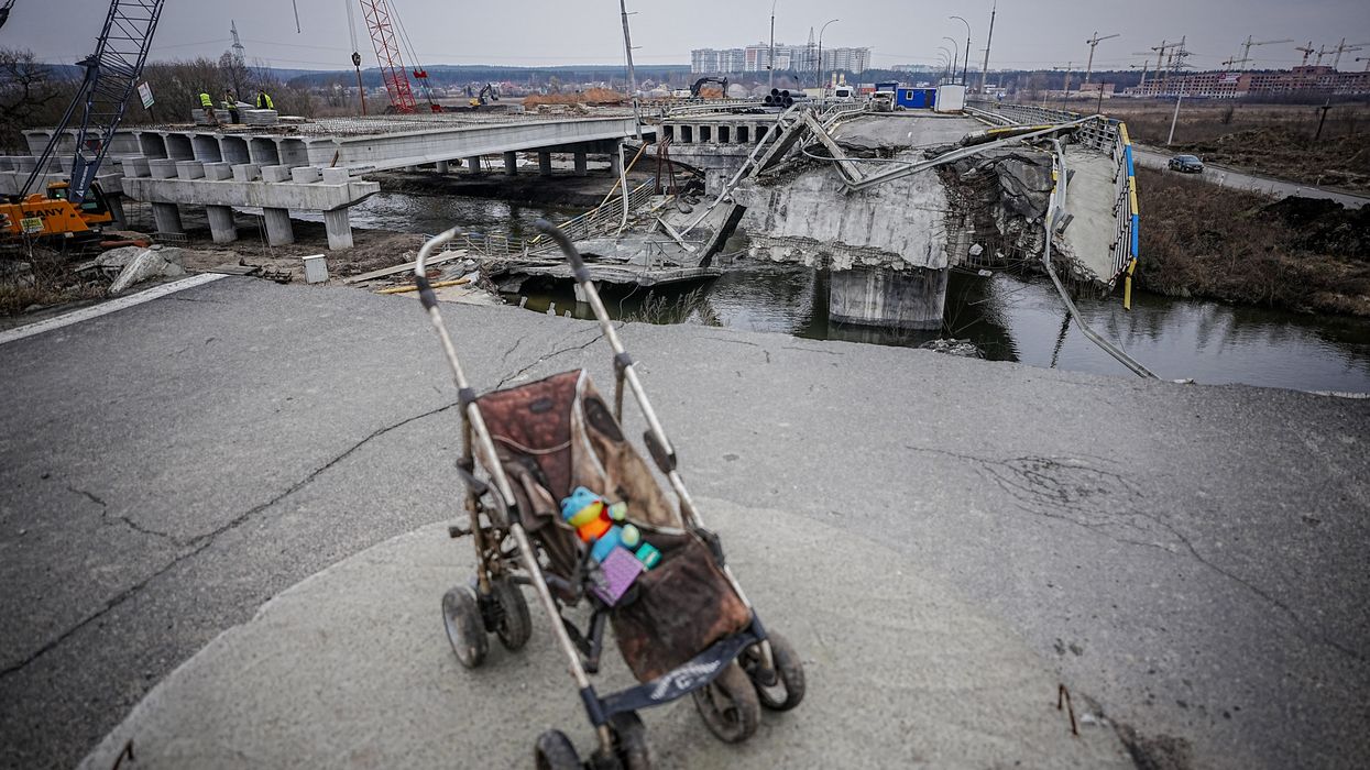 A baby carriage stands on the bridge destroyed during the war on the arterial road from Irpin near Kyiv.