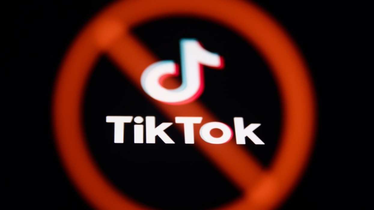 A ban sign displayed on a laptop screen and TikTok logo displayed on a phone screen are seen in this multiple exposure illustration photo taken in Poland on March 17, 2024.