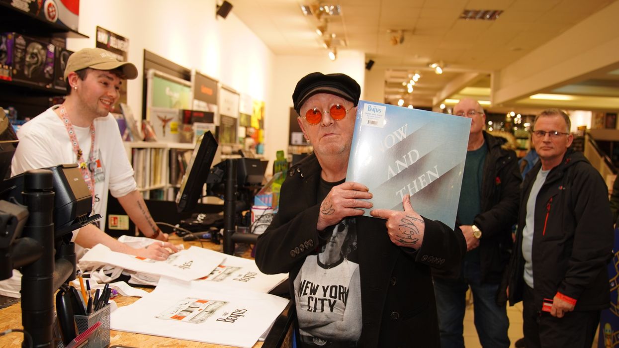 A Beatles superfan holds the first copy of the newly released last Beatles song, "Now and Then," at HMV Liverpool, on Nov. 3, 2023.