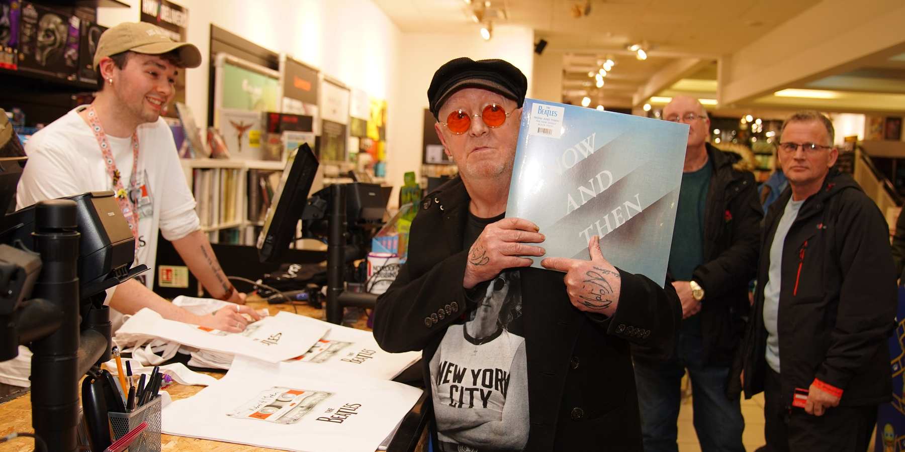 A Beatles superfan holds the first copy of the newly released last Beatles song, "Now and Then," at HMV Liverpool, on Nov. 3, 2023.