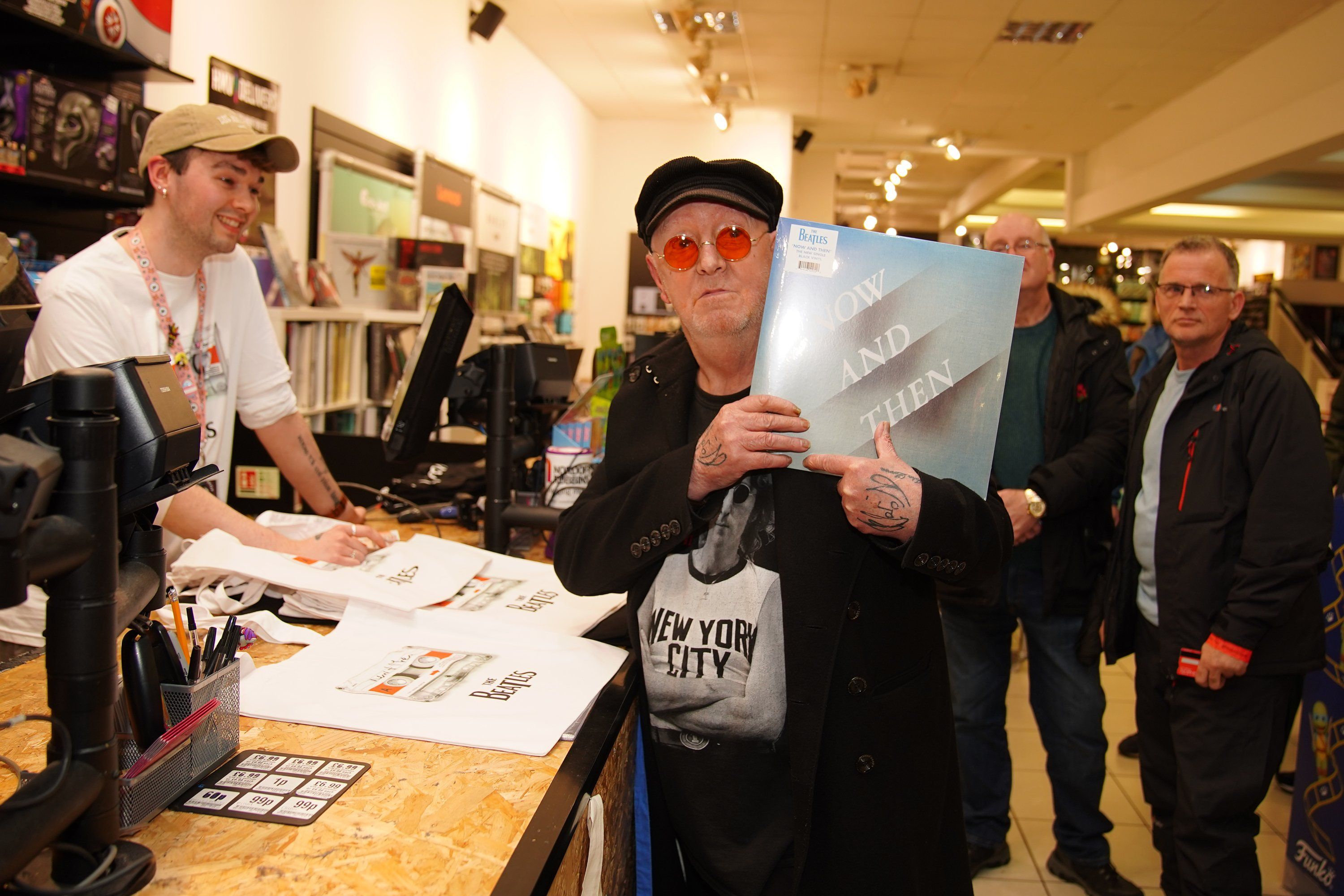 A Beatles superfan holds the first copy of the newly released last Beatles song, "Now and Then," at HMV Liverpool, on Nov. 3, 2023.