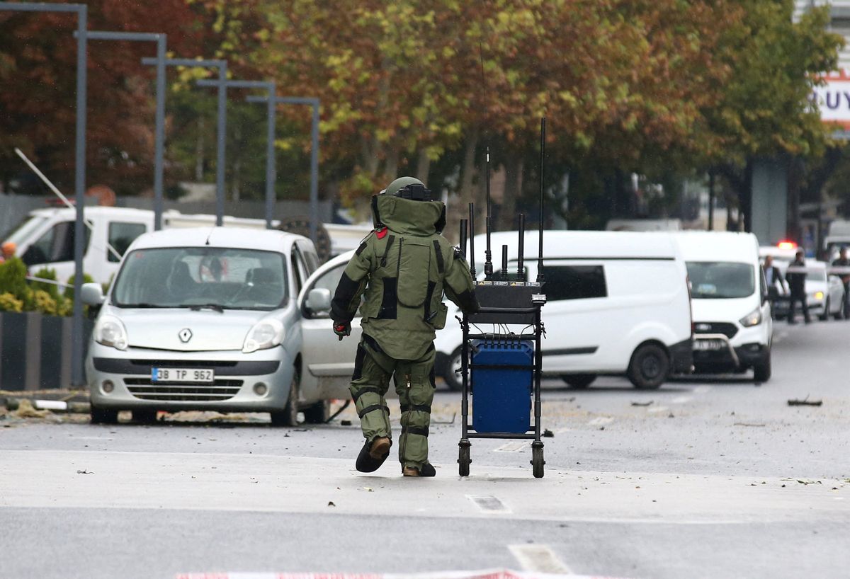 A bomb disposal expert works at the scene after a bomb attack in Ankara, Turkey.
