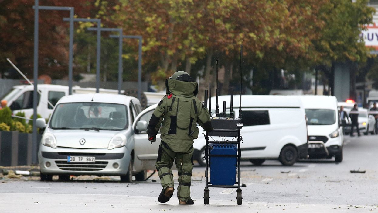 A bomb disposal expert works at the scene after a bomb attack in Ankara, Turkey.