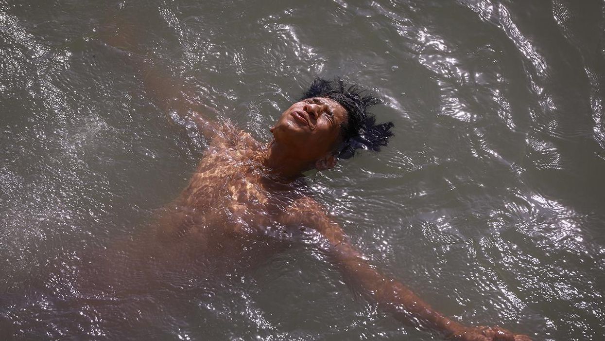 A boy swims in the Tigris River at Baghdad's Al-Adhamiyah neighbourhood to cool off amid an ongoing heatwave.