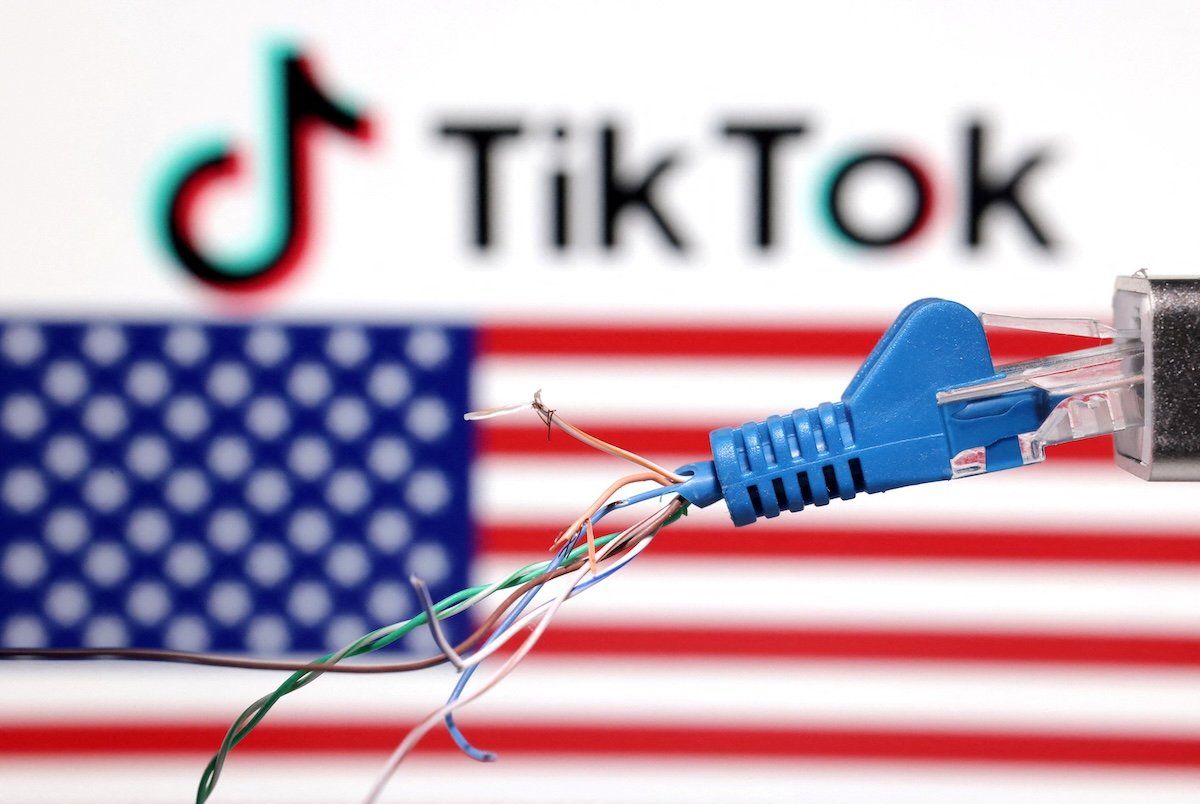 A broken ethernet cable is seen in front of a US flag and TikTok logo.