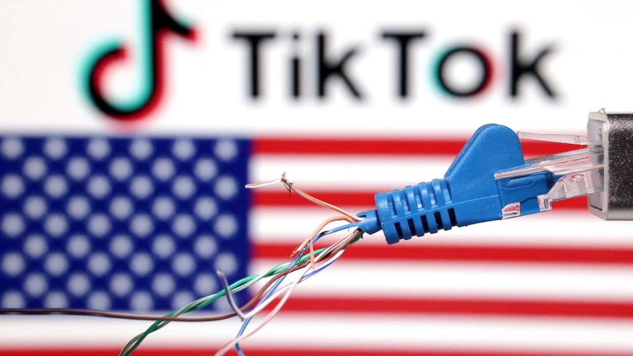 A broken ethernet cable is seen in front of a US flag and TikTok logo.