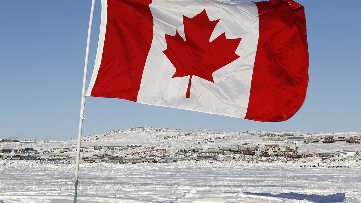 A Canadian flag is pictured on Frobisher Bay in Iqaluit, Nunavut February 23, 2012.