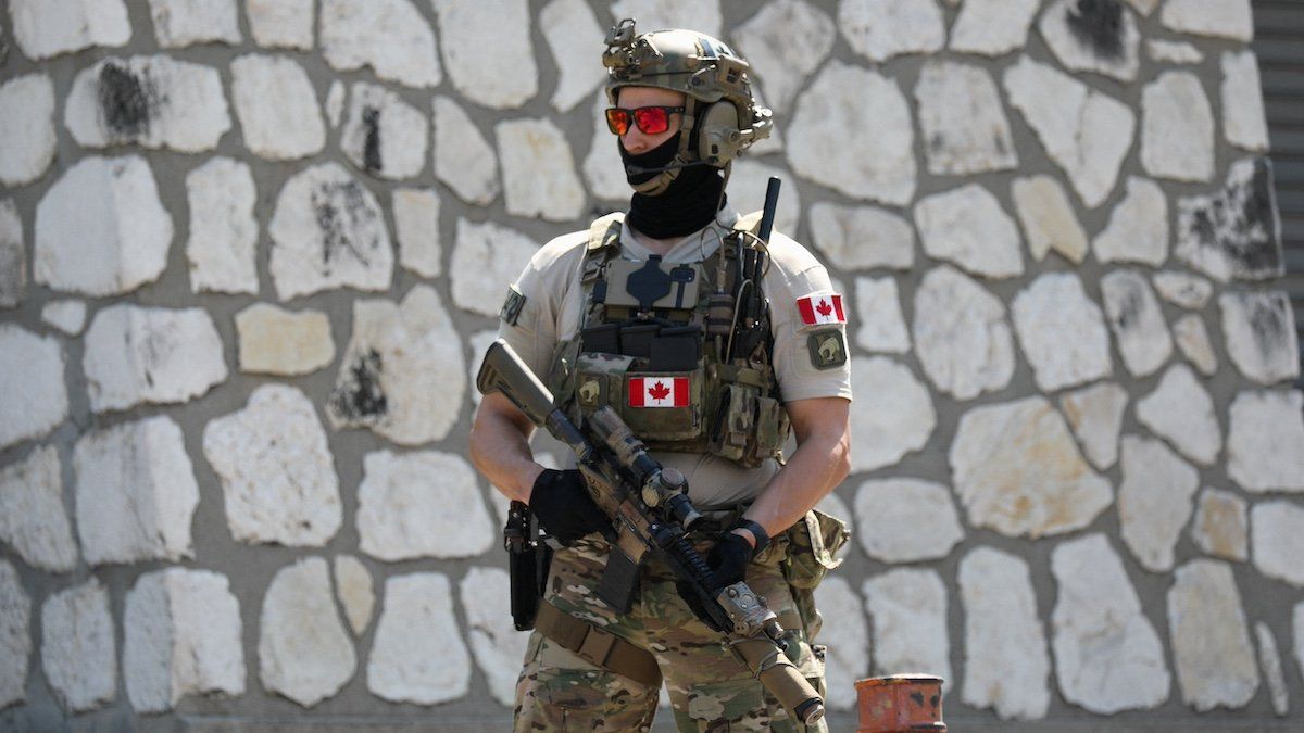 ​A Canadian soldier stands guard by the Canadian embassy as violence spreads and armed gangs expand their control over the capital, in Port-au-Prince, Haiti March 29, 2024. 