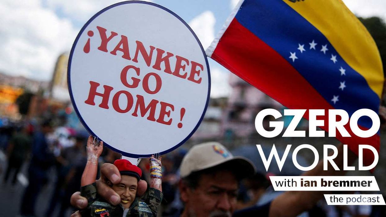 A Chavista holds a sign saying Yankee Go Home