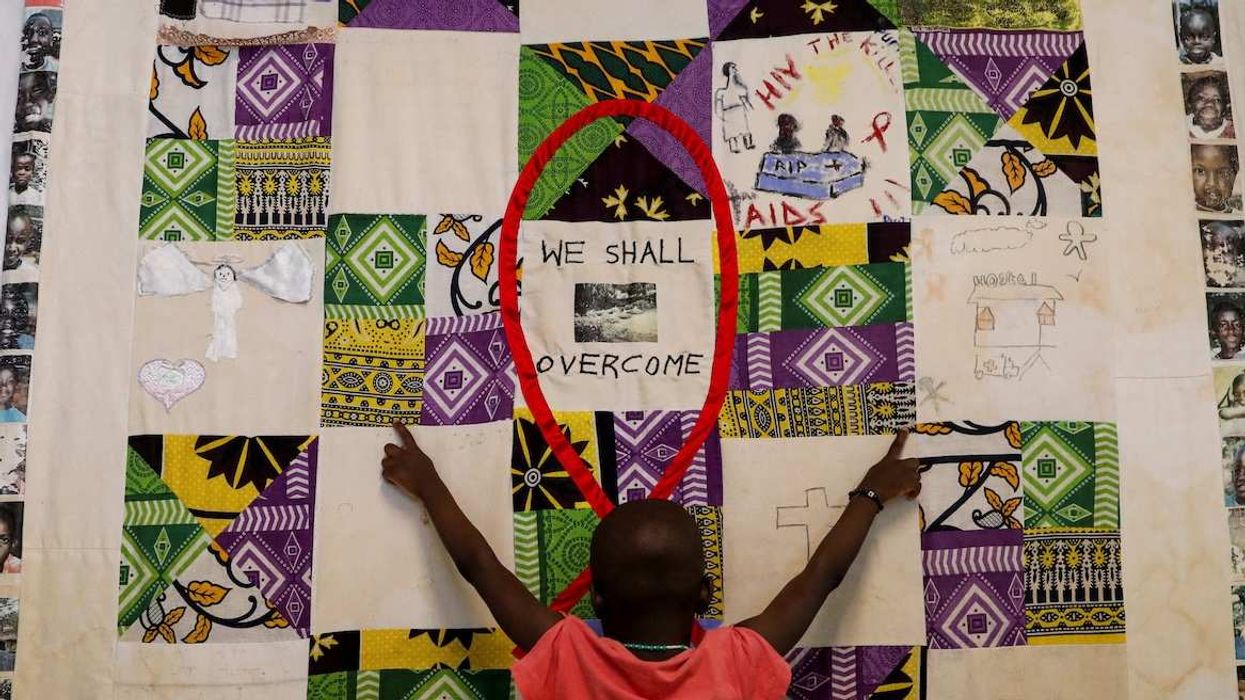 A child plays at an advocacy wall after receiving a dose of antiretroviral ARV drugs used to prevent HIV from replicating, at the Nyumbani Children's Home, which cares for more than 100 children with HIV.
