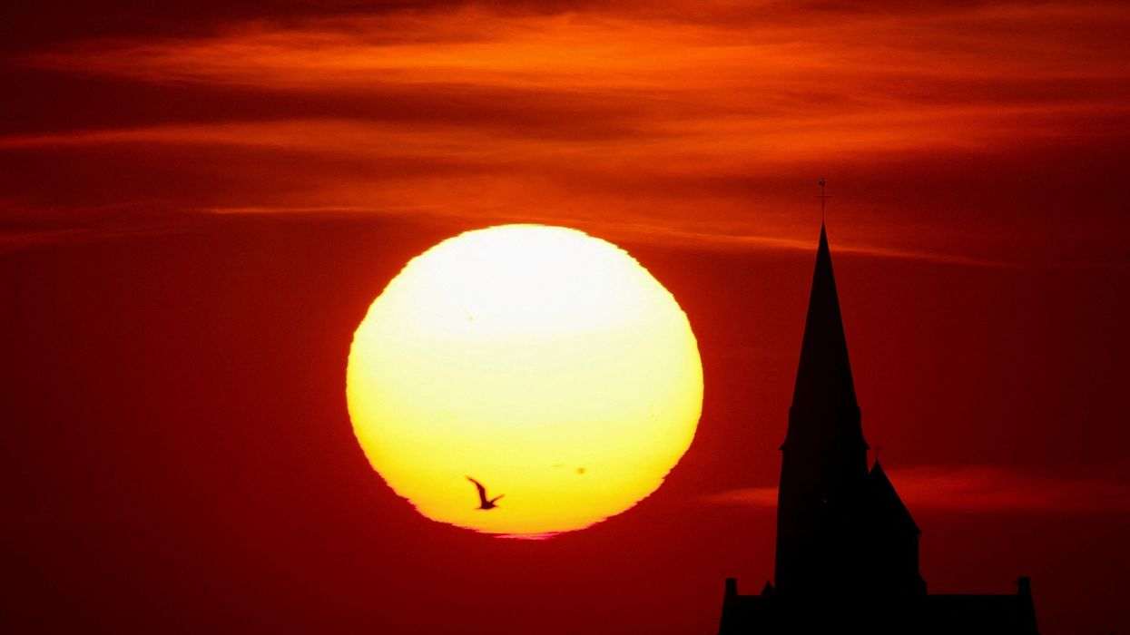 A church is pictured during sunset as a heat wave hits Europe in Oisy-le-Verger, France.