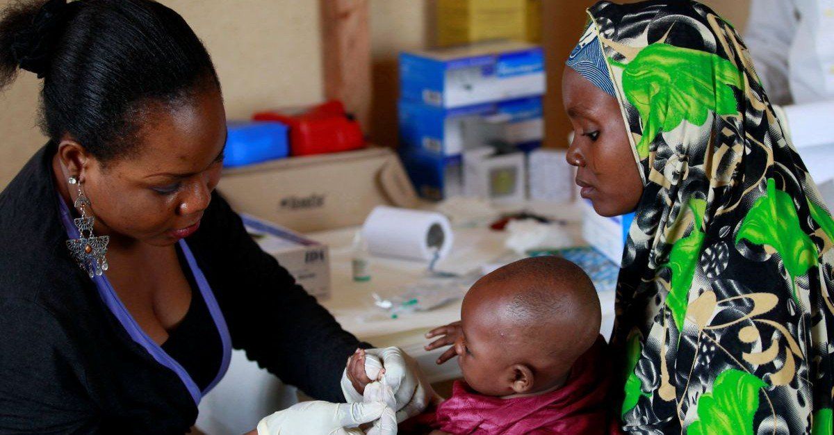 ​A clinic support staff takes blood sample from a child at a clinic operated by Doctors without Borders in Bagega village in northeastern state of Zamfara August 14, 2013. Picture taken August 14, 2013. 