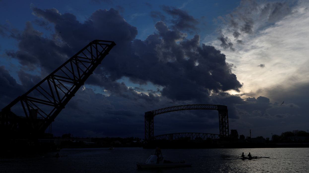 A crew rows along the Cuyahoga river at sunset in the Flats section of Cleveland, Ohio, U.S., October 23, 2020.
