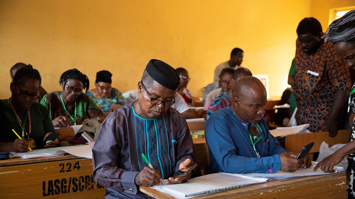 A day after the elections, officials tally votes at a collation centre previously stormed by unknown assailants in Lagos, Nigeria on February 26, 2023.