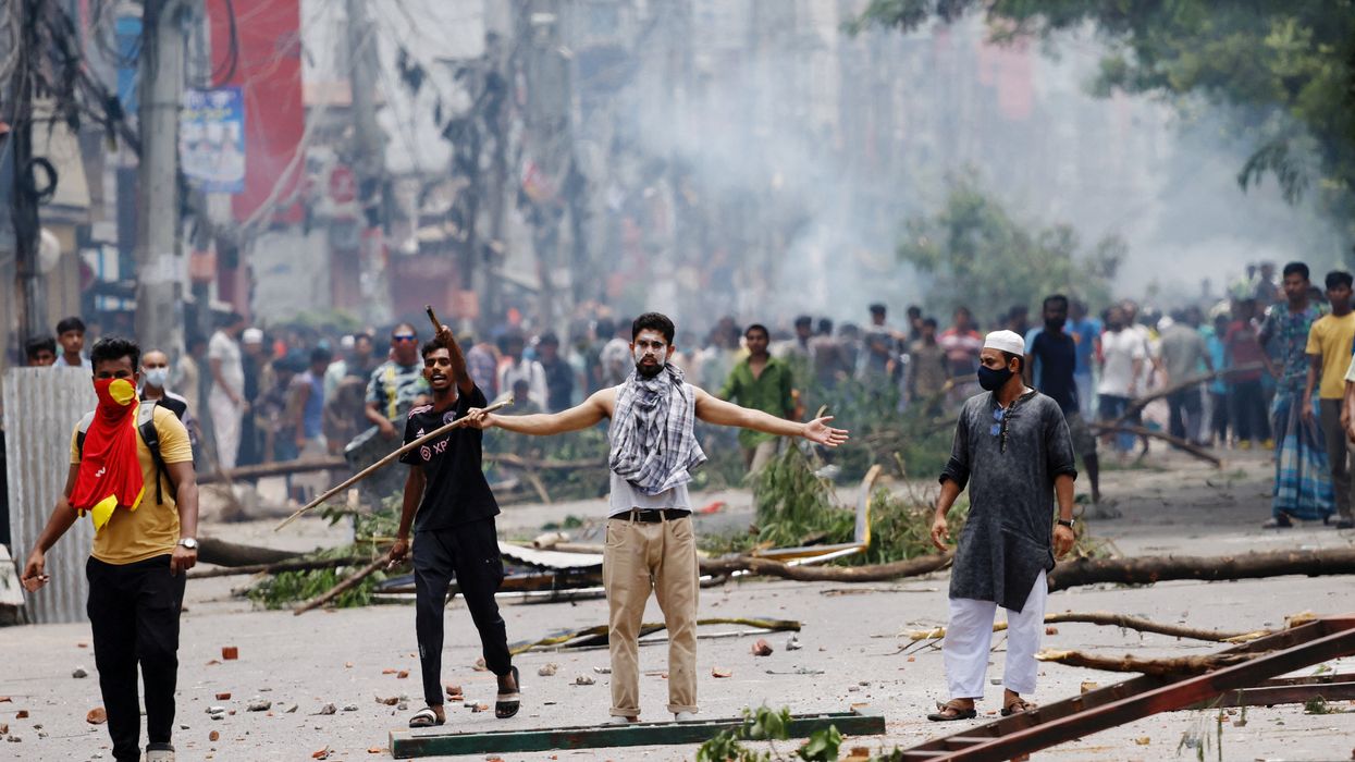 A demonstrator gestures as protesters clash with Border Guard Bangladesh (BGB) and the police outside the state-owned Bangladesh Television as violence erupts across the country after anti-quota protests by students, in Dhaka, Bangladesh, July 19, 2024.