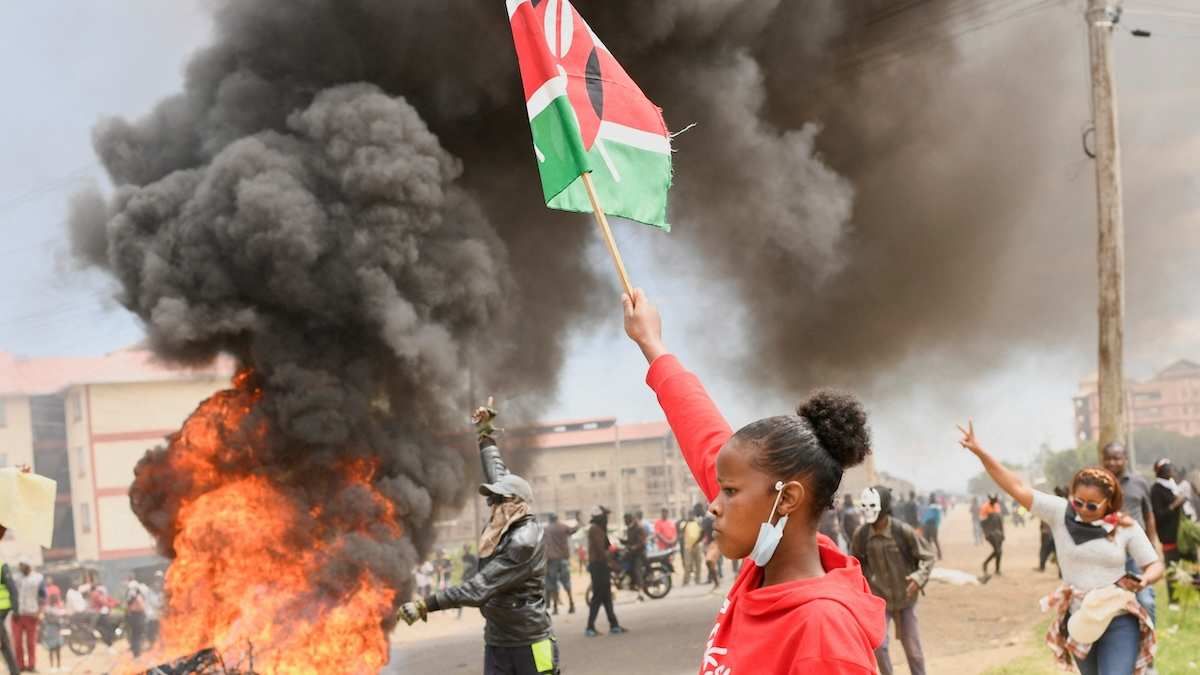 A demonstrator holds a Kenyan flag during a protest against a US-backed Ebola quarantine plan