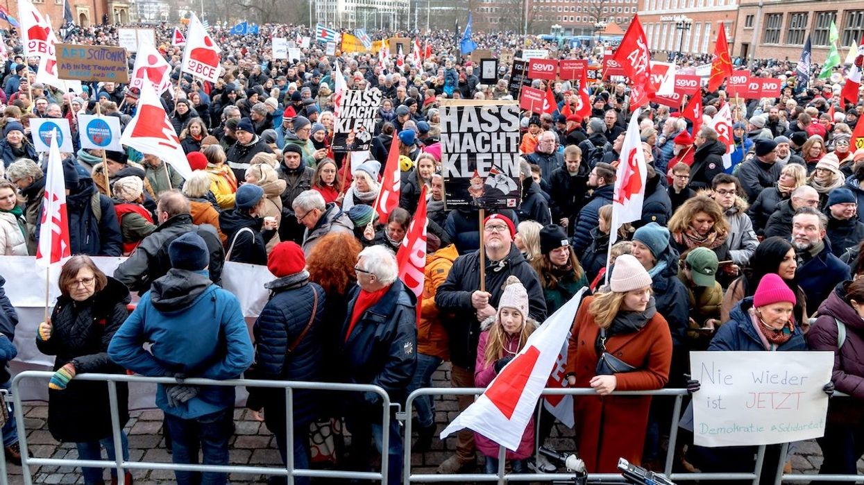 A demonstrator holds a sign reading "Hate makes you small" at a rally organized by the German Trade Union Confederation on "For Democracy and Solidarity" on Jan. 27, 2024.