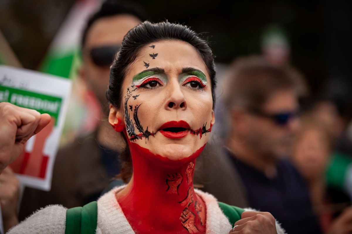 A demonstrator wears elaborate face paint during a march for Mahsa (Zhina) Amini and those protesting her death in Iran. 