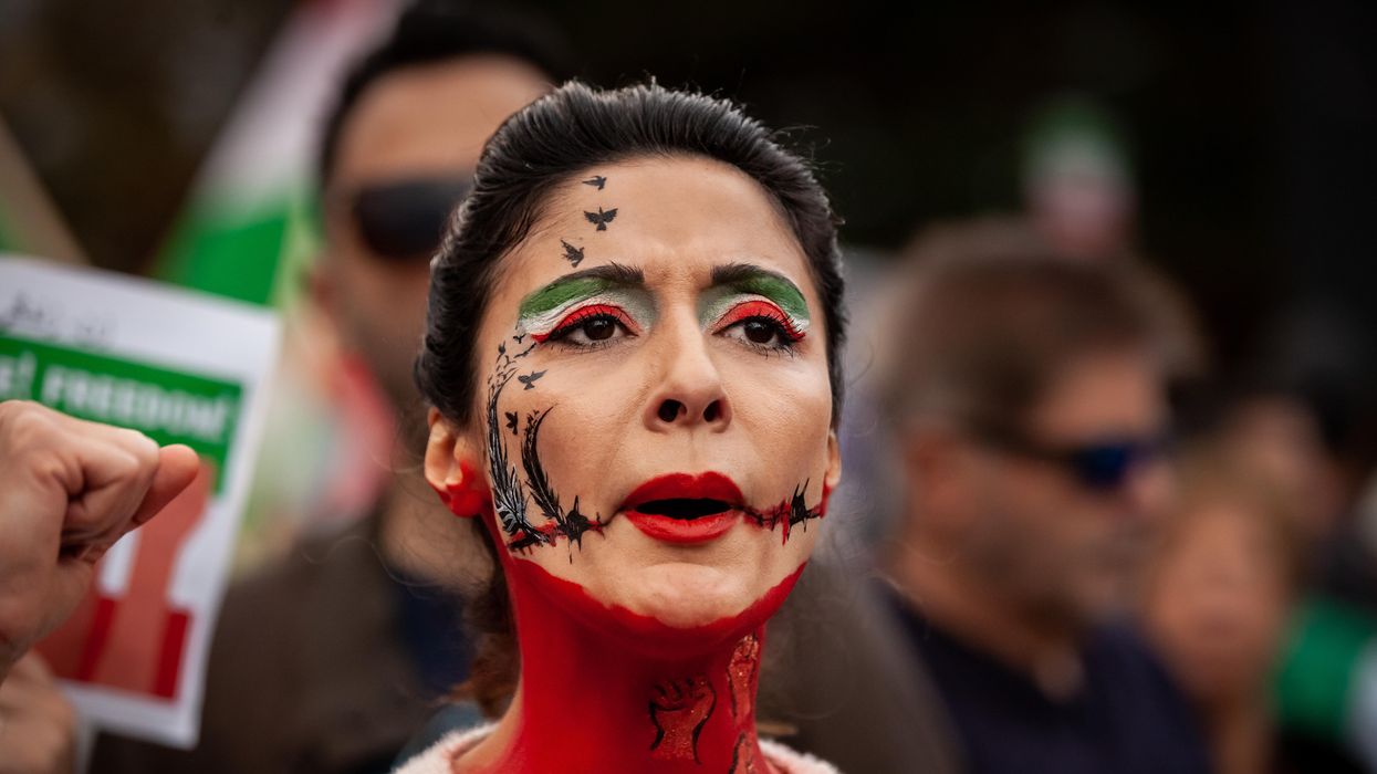 A demonstrator wears elaborate face paint during a march for Mahsa (Zhina) Amini and those protesting her death in Iran.