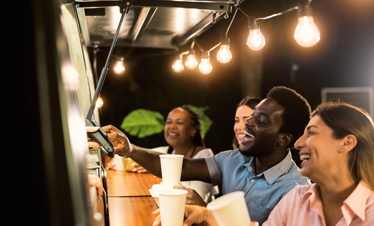 A diverse group of people using digital payments