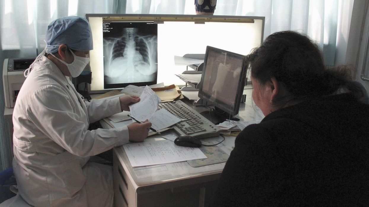 A doctor checks the progress of a patient with tuberculosis at the Beijing Chest Hospital March 31, 2009. Health officials gathered in Beijing on Wednesday warned against deadly drug-resistant strains of tuberculosis, which are spreading fastest in developing countries that lack the infrastructure to tackle the disease.