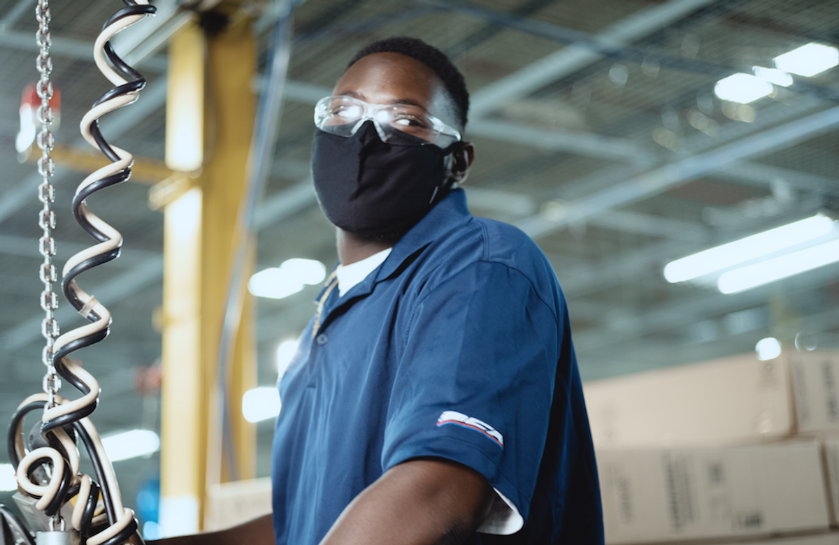 A factory worker. Walmart commits $350 billion to support American jobs