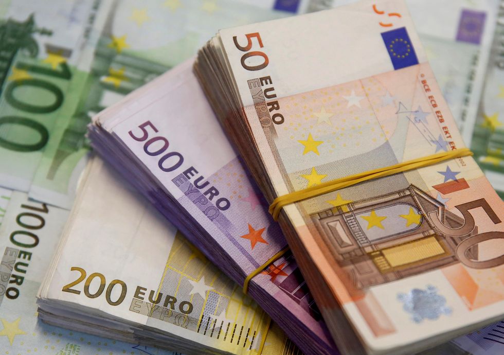 A few stacks of Euro bills, in 200, 500, and 50 euro denominations