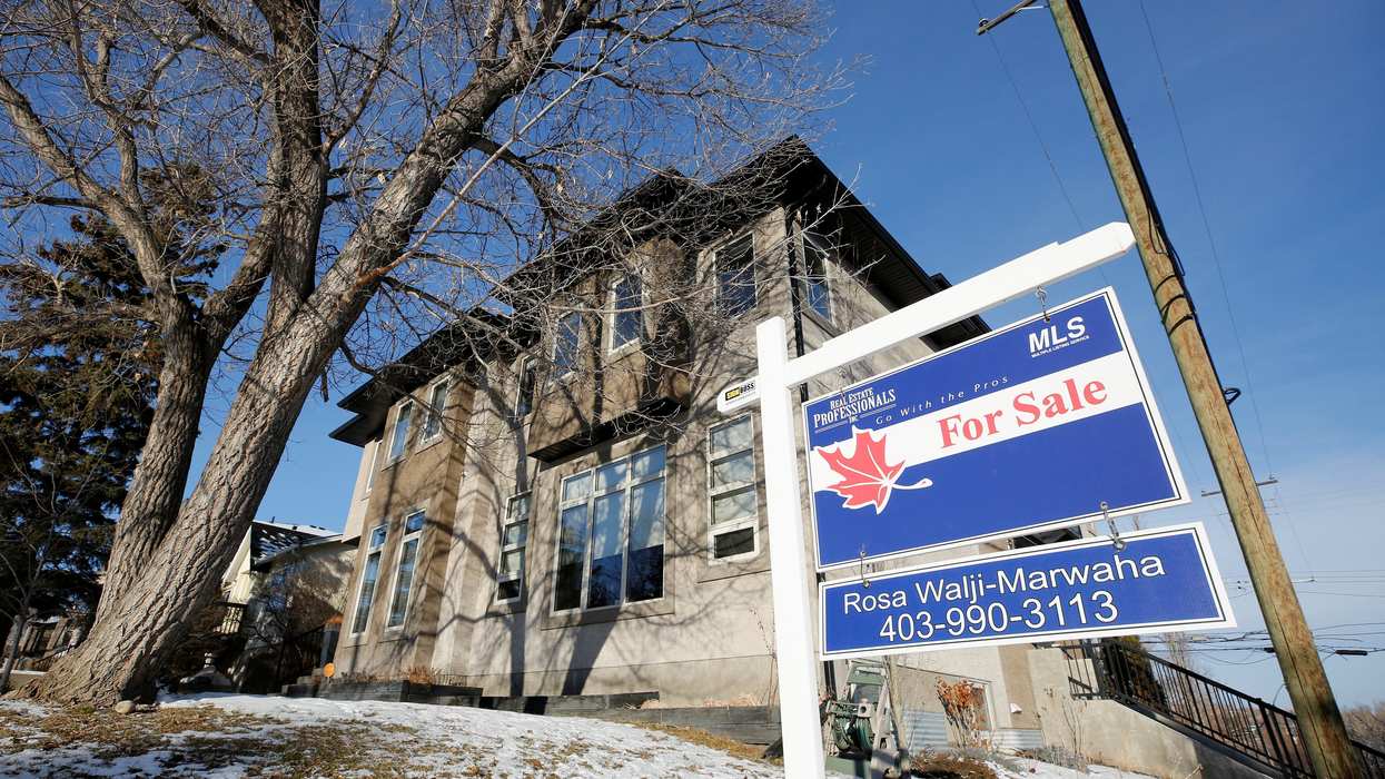A "For Sale" sign at a house in Calgary, Alberta.