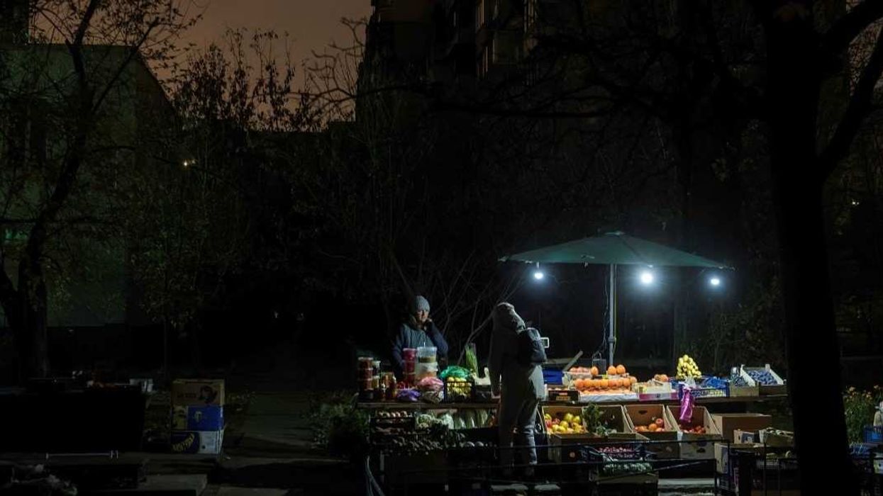 A fruit and vegetable stall is lit by small lamps during a blackout in a residential neighborhood in Kyiv, Ukraine, on November 6, 2025, after massive Russian attacks on Ukraine's energy infrastructure in October.
