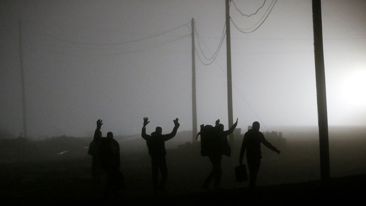 A group of migrants who said they were from Djibouti and Somalia follow railway tracks towards the Canada-U.S. border as seen from Emerson, Manitoba, Canada, March 27, 2017. Picture taken March 27, 2017.