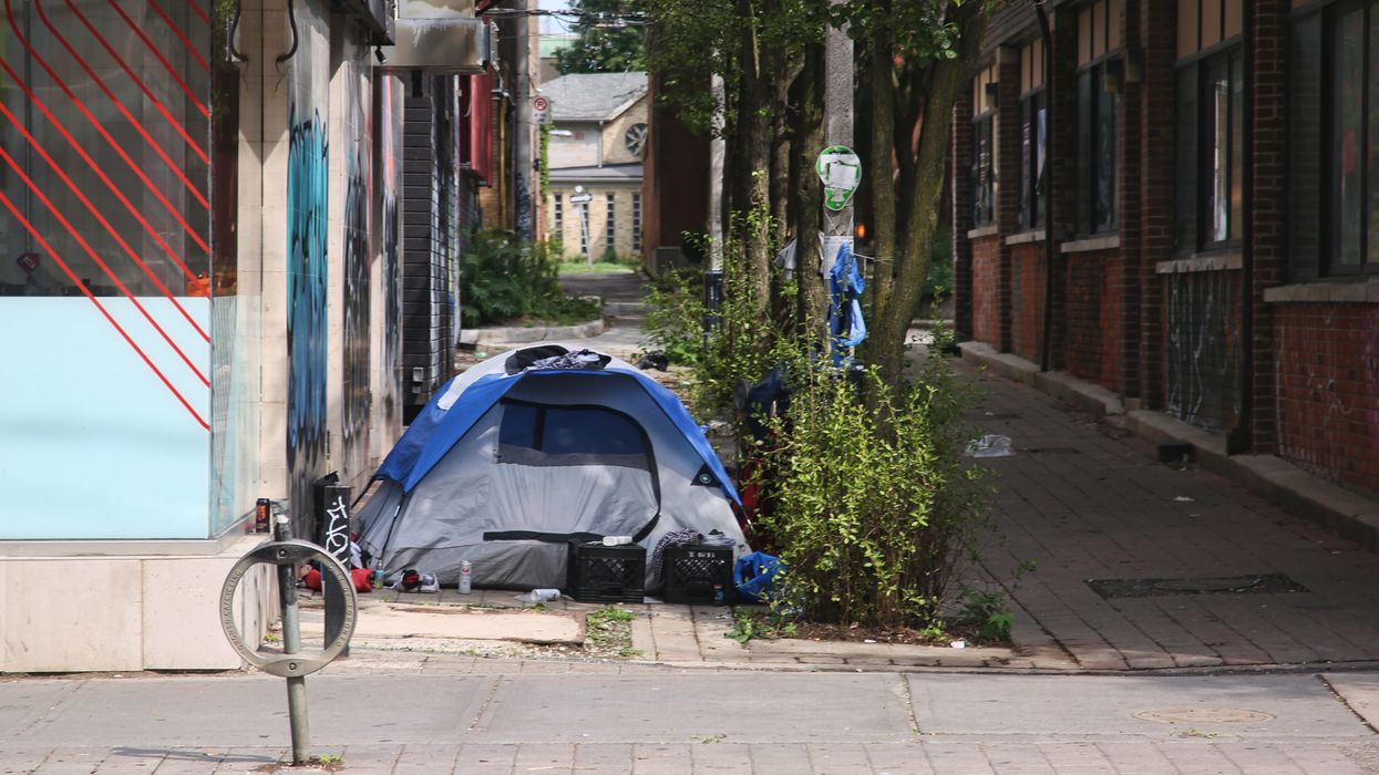 A homeless man's tent is seen in an alley in downtown Toronto, Ontario.