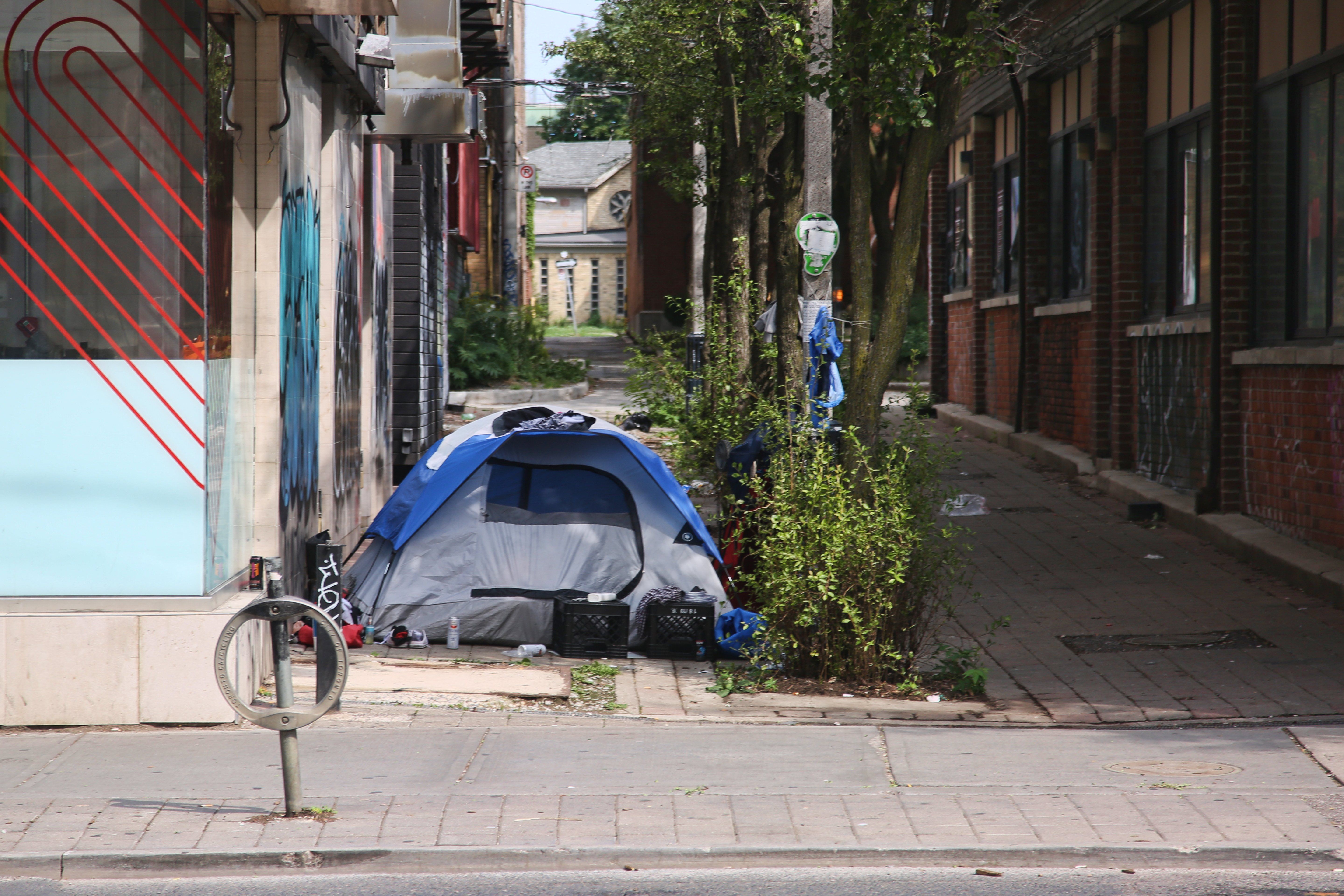 A homeless man's tent is seen in an alley in downtown Toronto, Ontario.