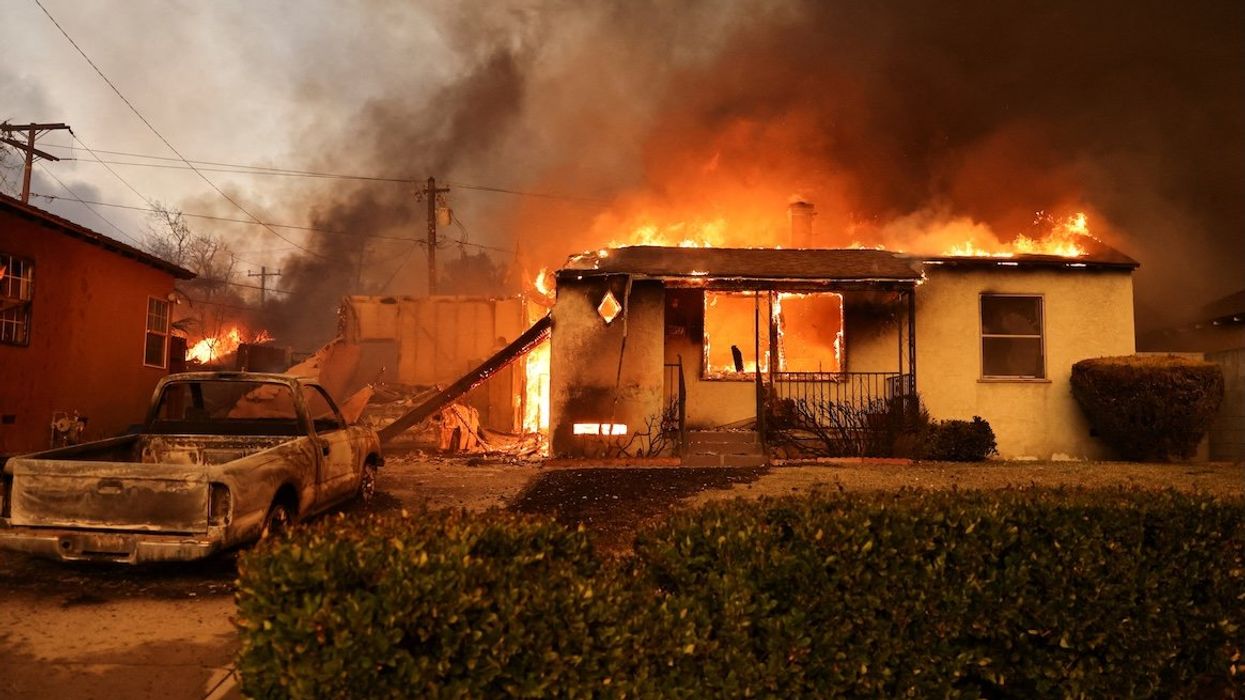 A house burns as powerful winds fueling devastating wildfires in the Los Angeles area force people to evacuate, in Altadena, California, on Jan. 8, 2025.