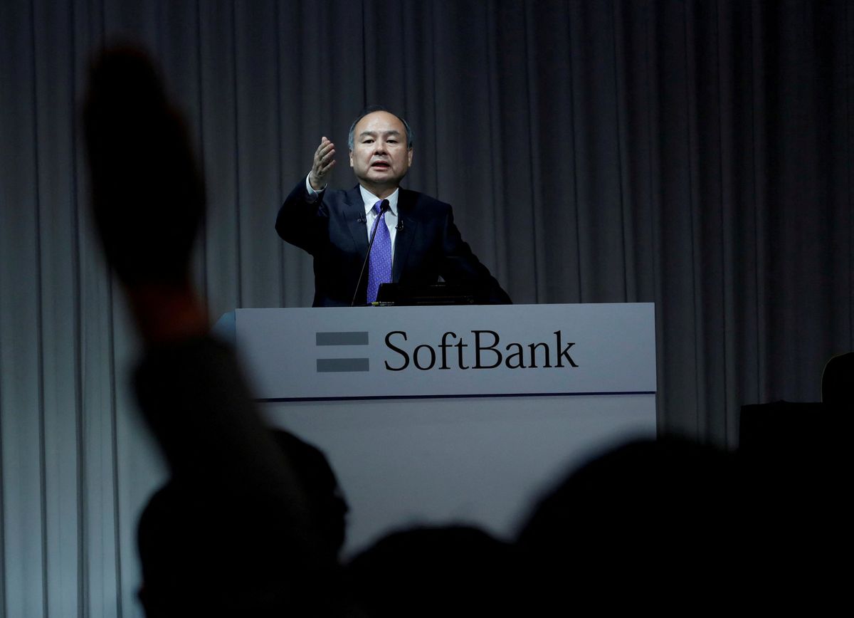A journalist raises her hand to ask a question to Japan's SoftBank Group Corp Chief Executive Masayoshi Son during a news conference in Tokyo.