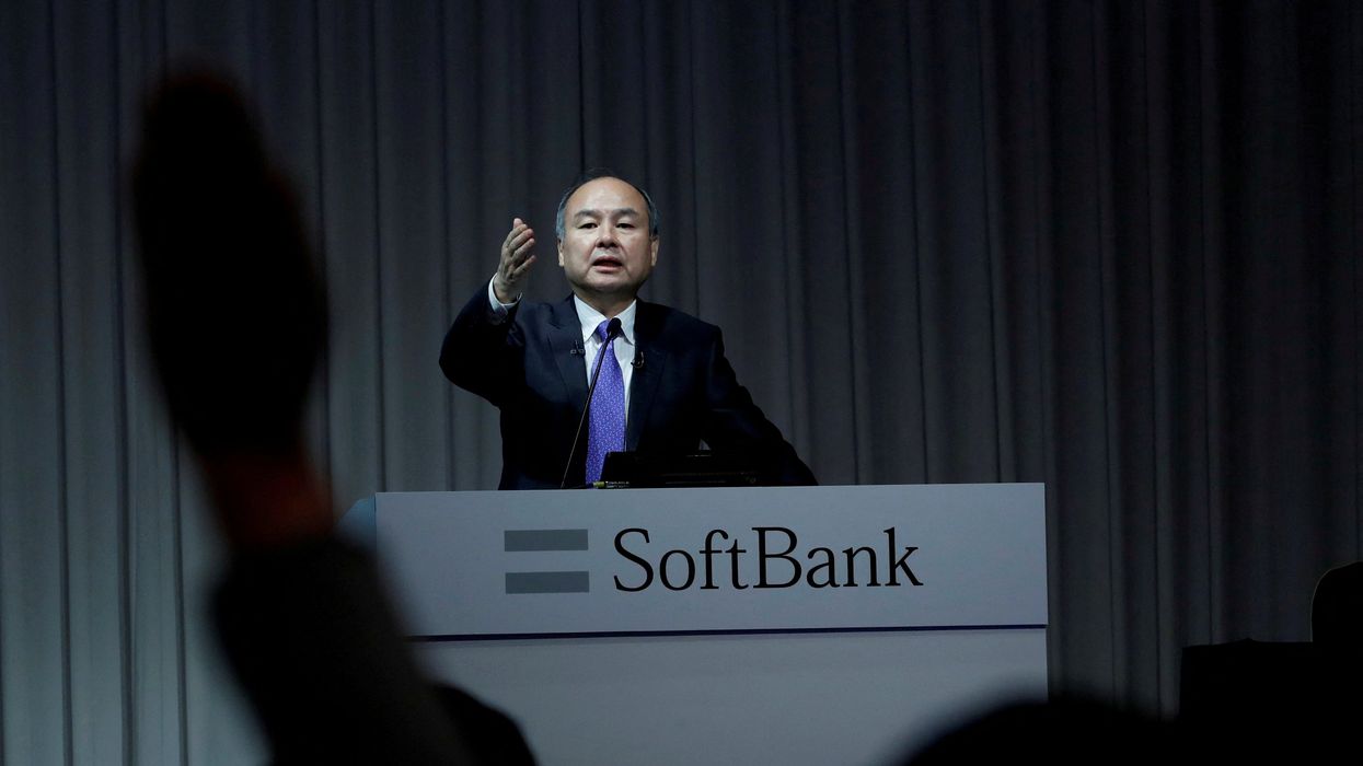 A journalist raises her hand to ask a question to Japan's SoftBank Group Corp Chief Executive Masayoshi Son during a news conference in Tokyo.