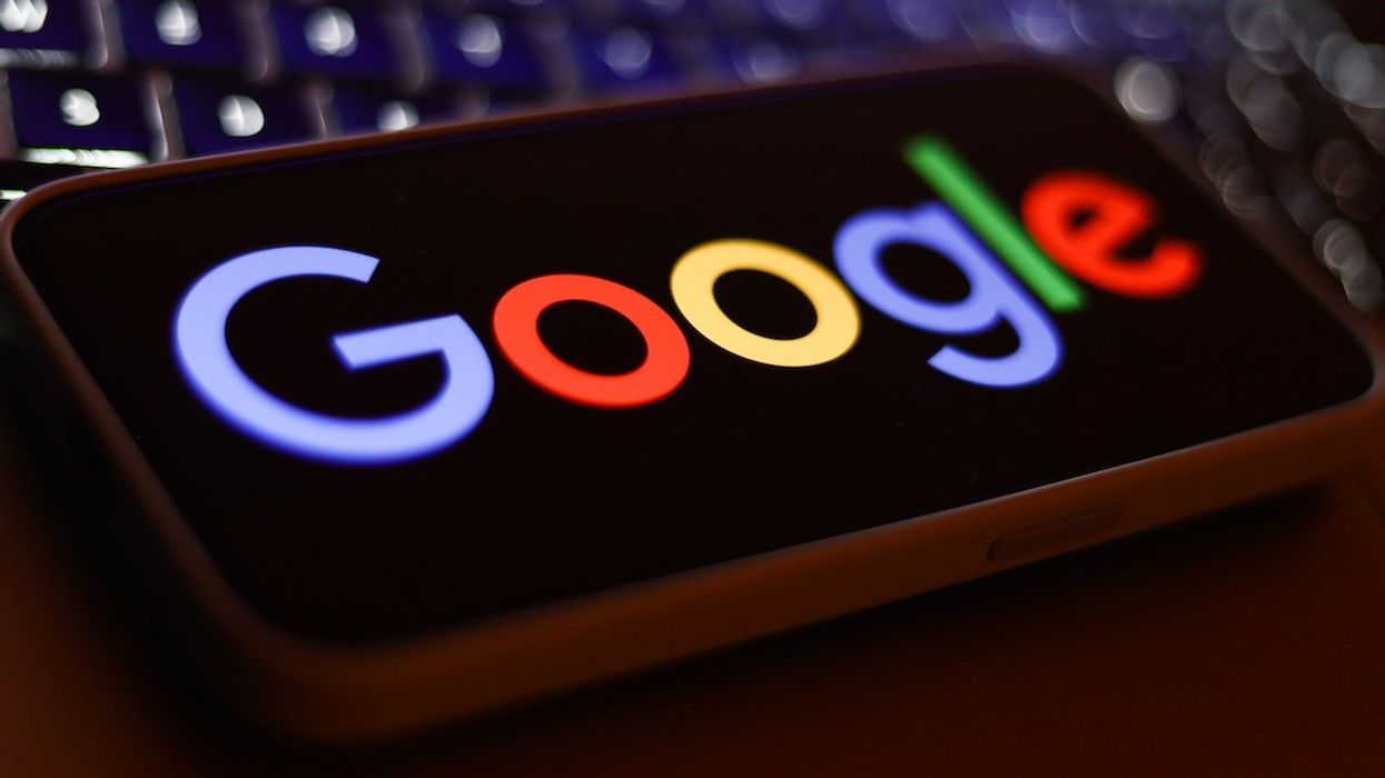 A laptop keyboard and Google logo displayed on a phone screen are seen in this illustration photo taken in Krakow, Poland on September 9, 2024.