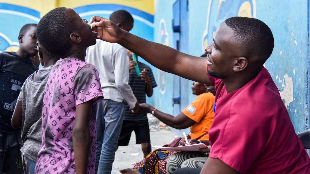 A man administers the cholera vaccine to a child at a temporary cholera treatment center set up to deal with the latest deadly cholera outbreak in Lusaka, Zambia.