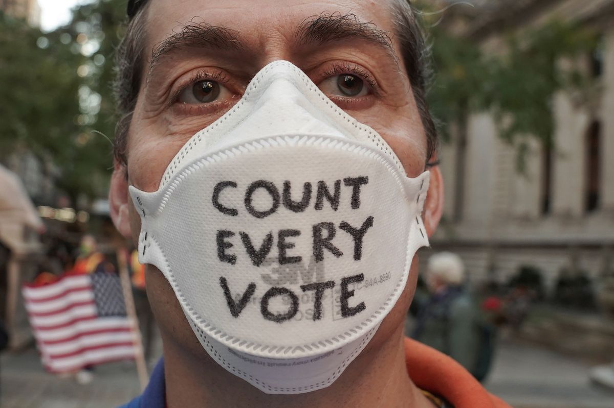 A man attends a "Count Every Vote" rally the day after the US election in New York City. Reuters