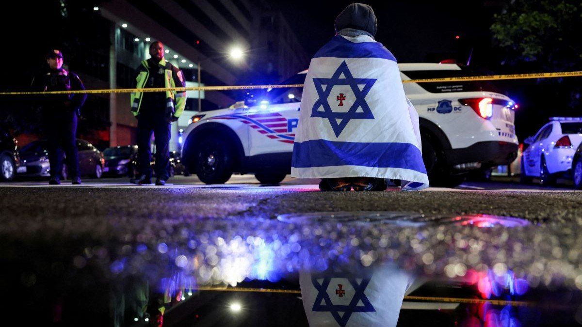 ​A man, draped in a version of the Israeli flag, stations himself outside the Capital Jewish Museum, in Washington, D.C., USA, on May 21, 2025.