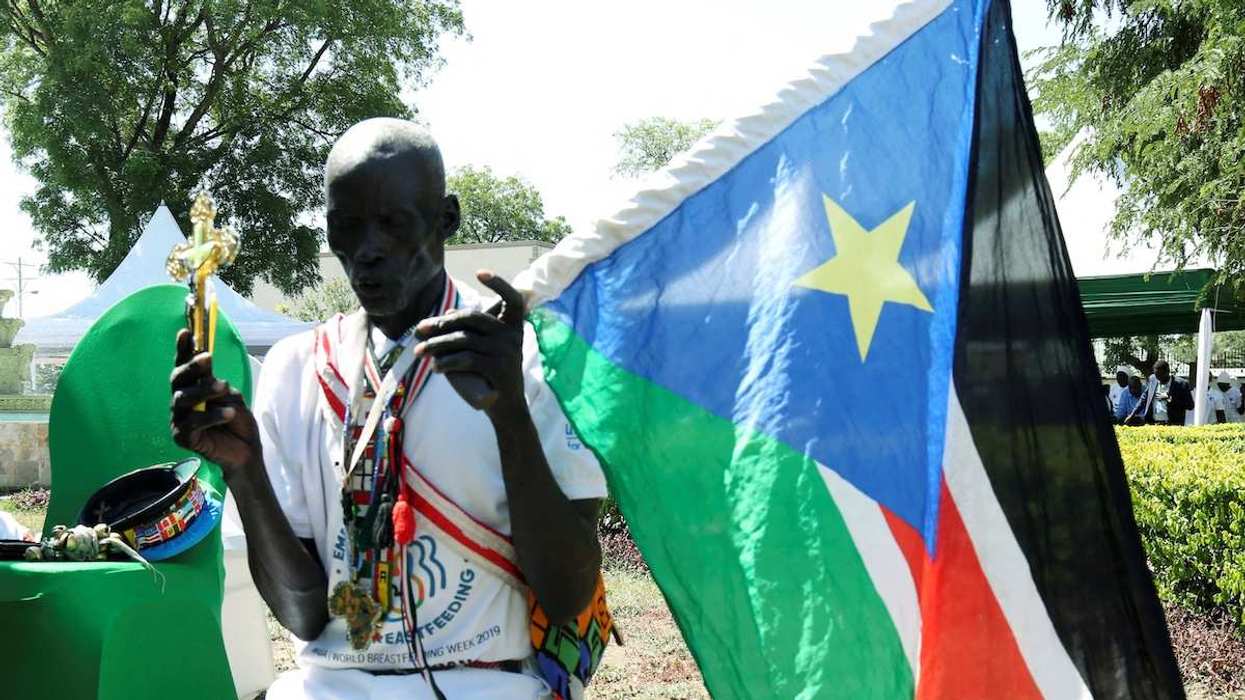 A man holding a South Sudan flag takes part in a national day of prayers for peace in Juba, South Sudan, on September 19, 2019.
