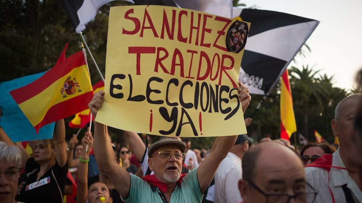 A man is seen holding up a placard against Spanish Prime Minister Pedro Sanchez as he takes part in a protest in solidarity with ceuta people, coinciding with Ceuta city day. The mass crossing of migrants into the city of Ceuta from Morocco has prompted several Spanish cities to call rallies and demonstrations in support of Ceuta and national sovereignty, as well as against the Spanish government's management.