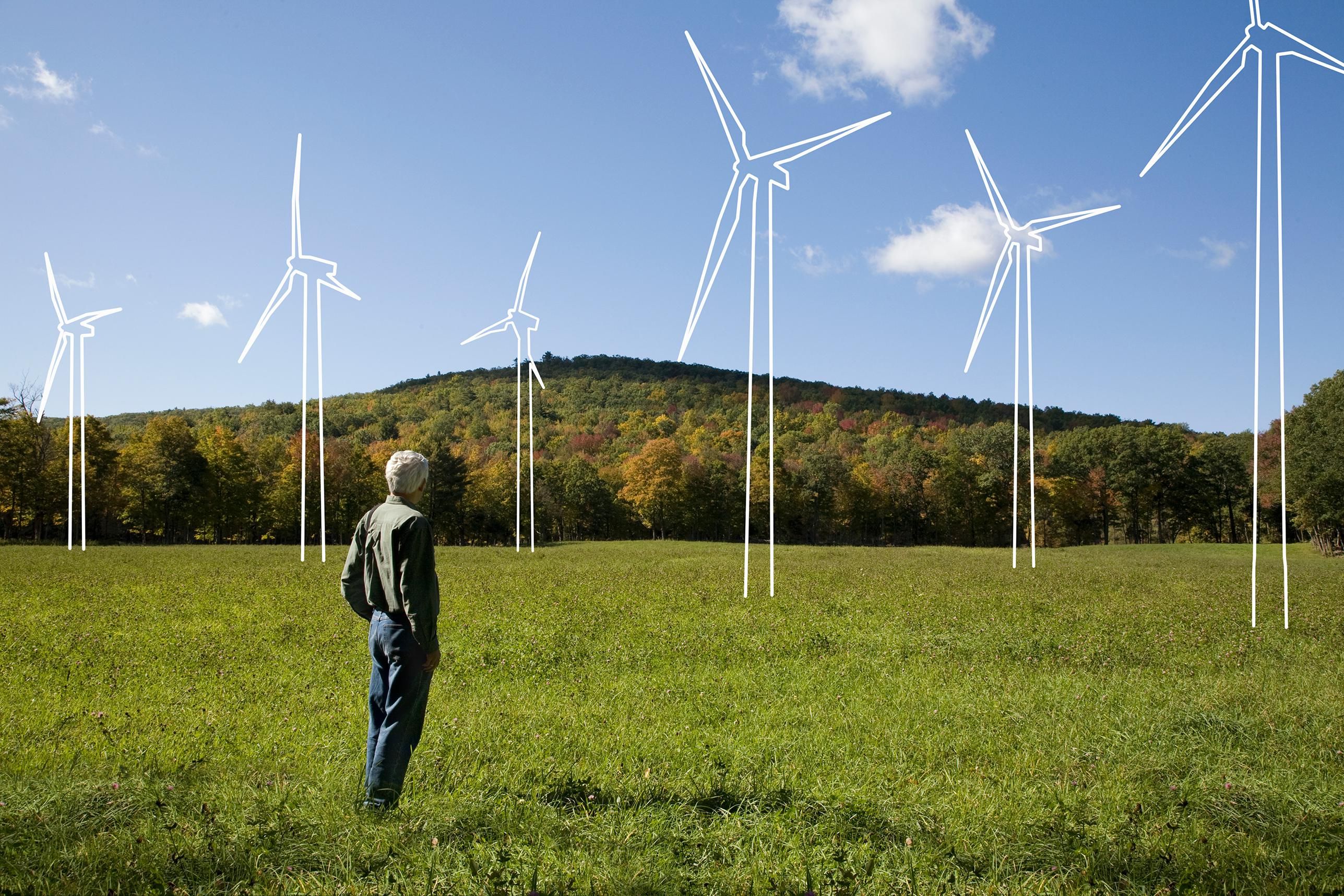 A man looks at a windmill farm. Bank of America to make a $1 trillion investment in sustainability by 2030