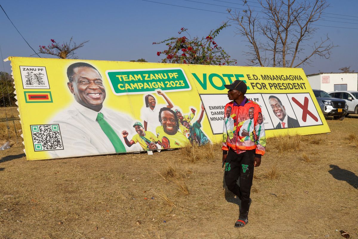 A man looks at the banner of Zimbabwe's President Emmerson Mnangagwa. 