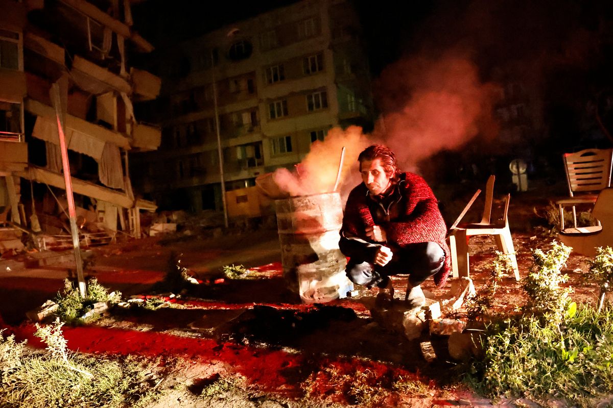 A man sits outside after an earthquake in Antakya in Hatay province, Turkey.