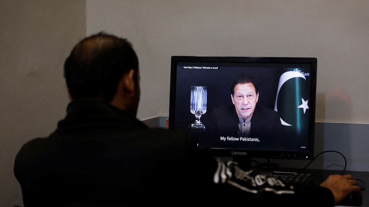 A man views a computer screen displaying the AI-crafted speech of former Prime Minister Imran Khan, to call for votes ahead of the general elections in Karachi, Pakistan, in early February 2024.