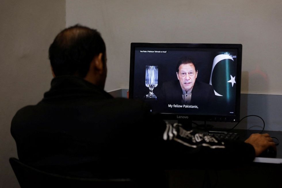 ​A man views a computer screen displaying the AI-crafted speech of former Prime Minister Imran Khan, to call for votes ahead of the general elections in Karachi, Pakistan, in early February 2024. 
