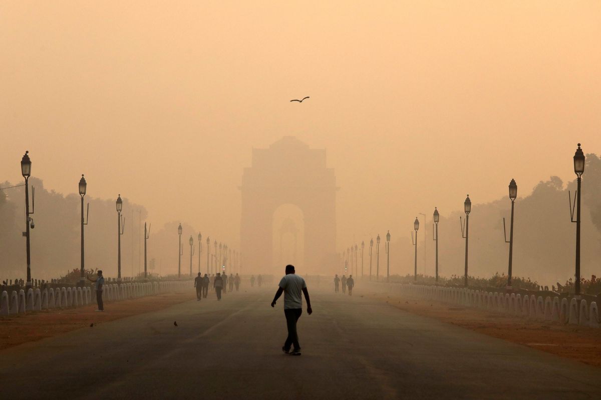 A man walks in front of the India Gate shrouded in smog in New Delhi. Reuters