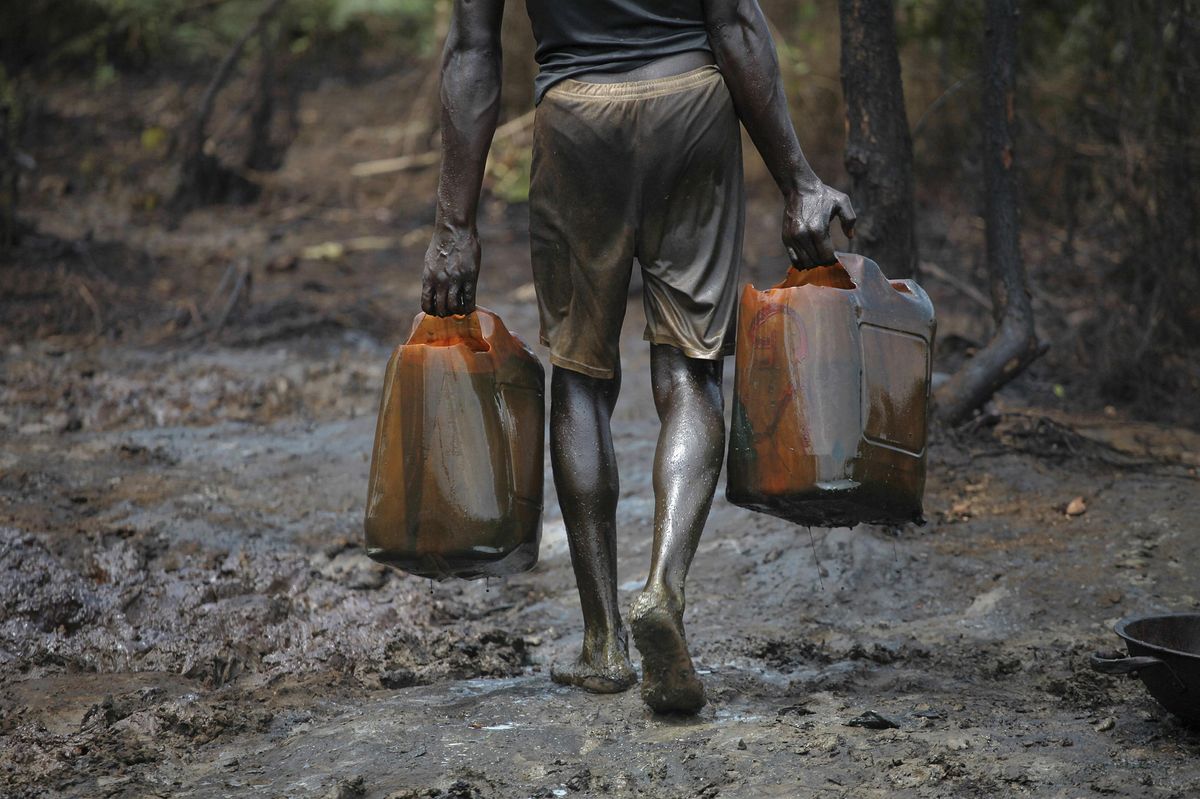 A man works at an illegal oil refinery site  in Bayelsa, Nigeria.