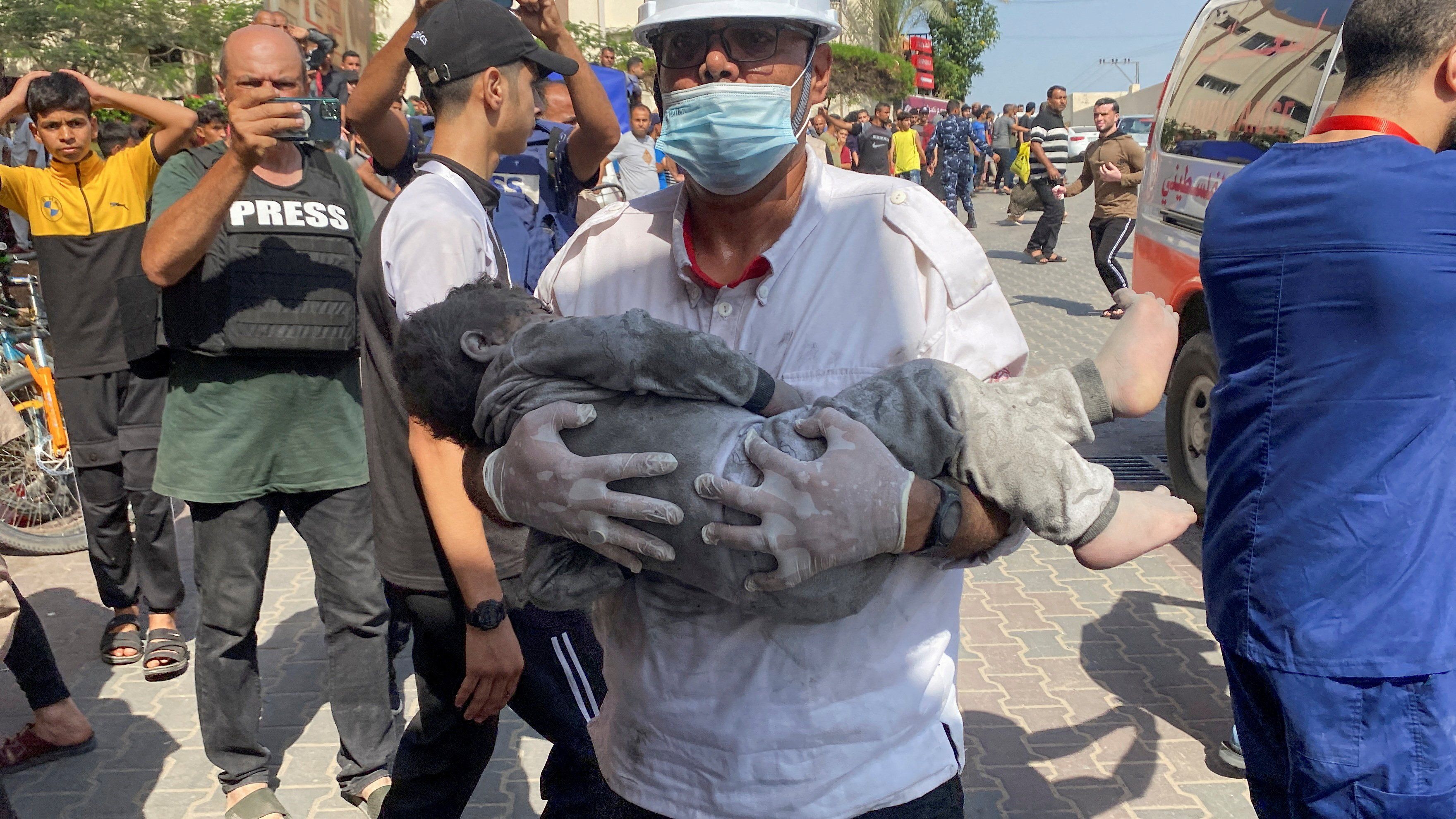 A medic carries a Palestinian boy killed in an Israeli strike near a hospital in Khan Younis in the southern Gaza Strip on Oct. 24, 2023.  