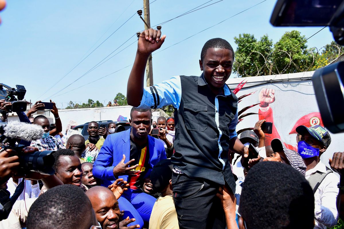 A member of former presidential candidate Robert Kyagulanyi also known as Bobi Wine's security detail celebrates after being released on bail, at the party's headquarters in Kampala, Uganda June 14, 2021. 